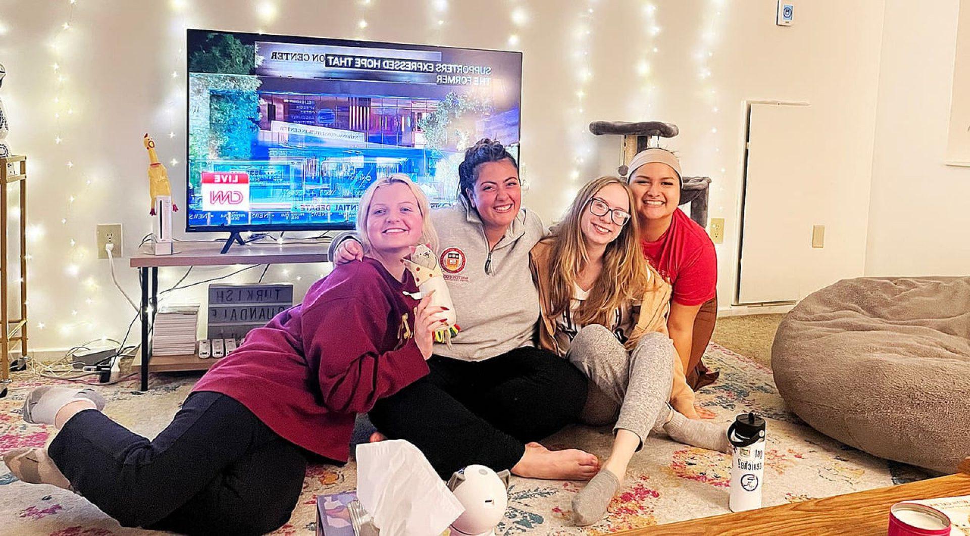 A group of students in front of a television